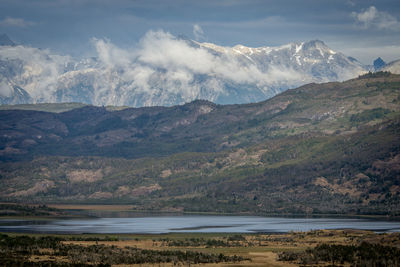 Scenic view of sea and mountains against sky