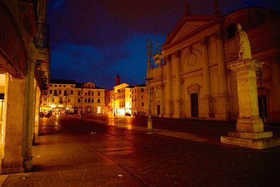 Illuminated buildings against sky at night