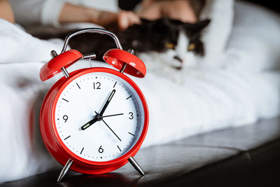 Close-up of clock on bed at home