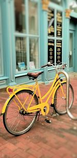 Bicycle parked on street against building