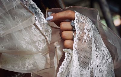 Cropped hand of woman wearing netting at home