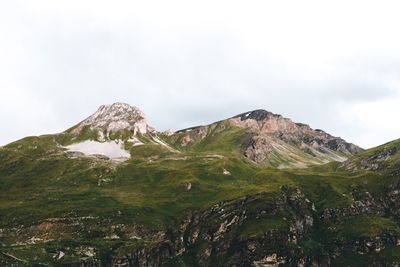 Scenic view of mountains against cloudy sky