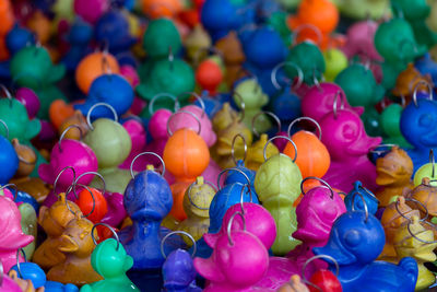 Full frame shot of colorful duck shape key rings for sale at market