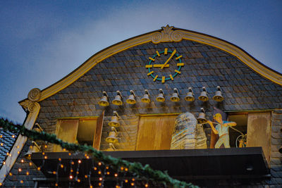 Low angle view of cross on roof of building