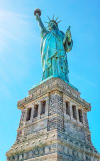 Low angle view of statue against blue sky