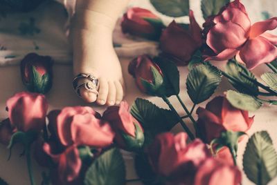 Low section of woman with flowers and leaves