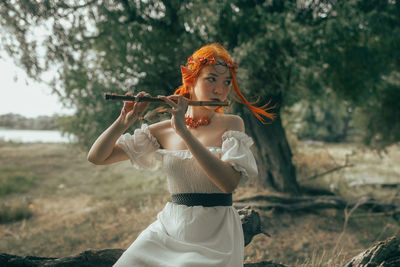 Side view of young woman playing violin