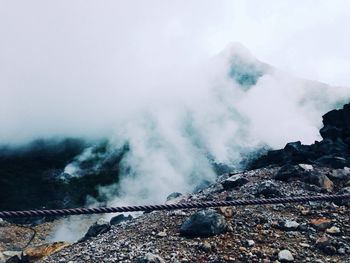 Scenic view of mountain against cloudy sky