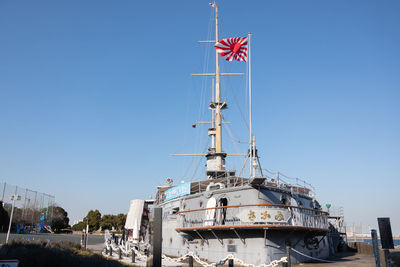 Low angle view of crane against clear blue sky