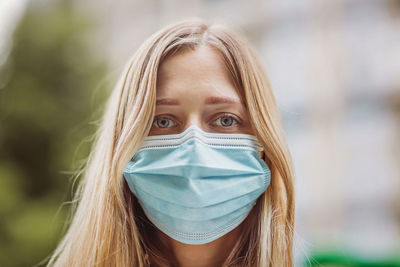 Portrait of beautiful woman wearing mask outdoors