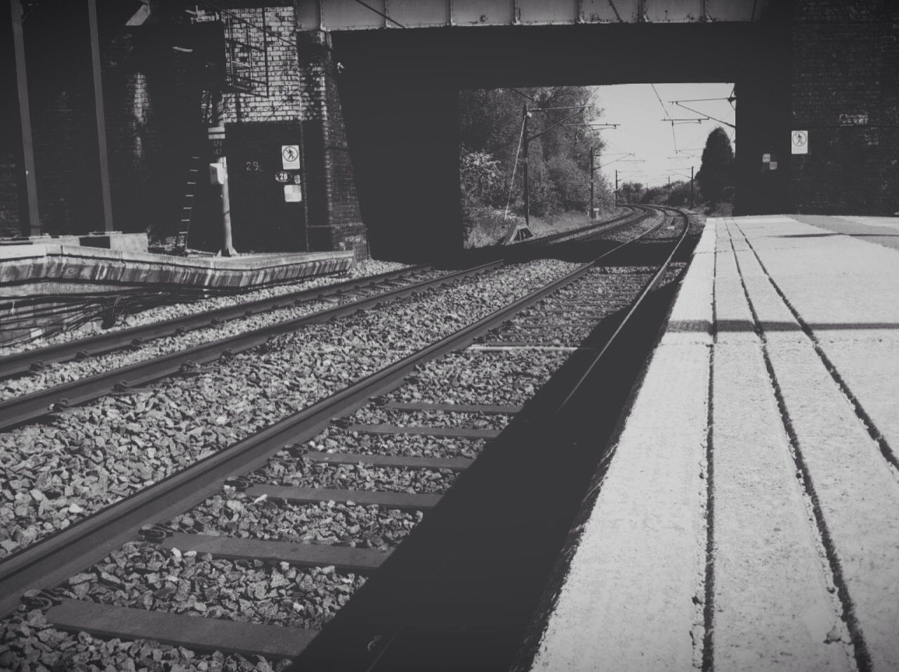 railroad track, built structure, architecture, rail transportation, transportation, railroad station platform, the way forward, railroad station, connection, high angle view, diminishing perspective, bridge - man made structure, building exterior, public transportation, city, railing, vanishing point, incidental people, travel, metal