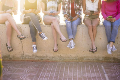 Low section of people sitting on floor