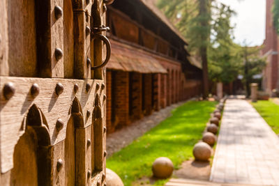 Old open wooden door with carved pattern and metal knob in a medieval castle