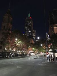 Illuminated city street and buildings at night