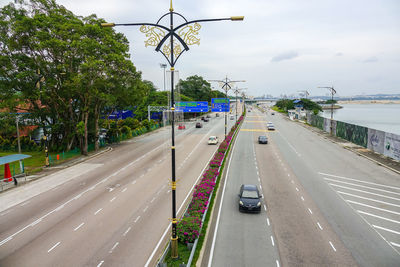 Traffic on road in city against sky