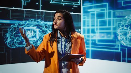 Portrait of young woman using mobile phone in office