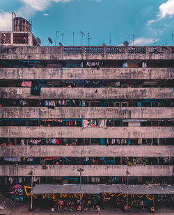 Old apartment against sky in city