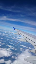 Aerial view of aircraft wing against sky