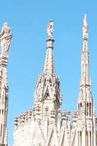 Low angle view of statue of building against clear sky