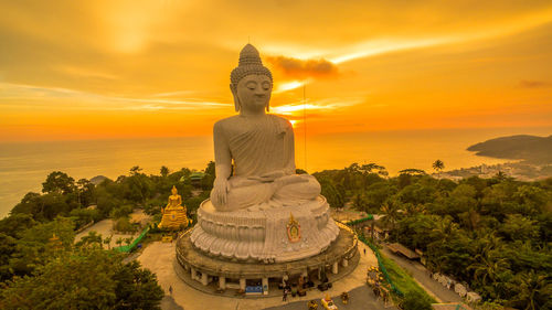 Statue of temple against sky during sunset