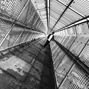 Tilt image of man walking on footbridge