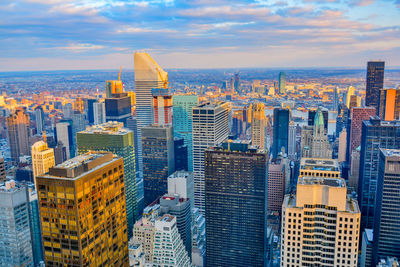 High angle view of cityscape against cloudy sky