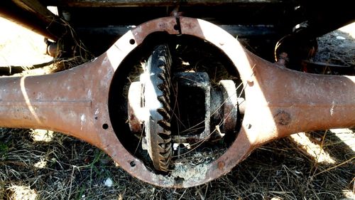 Close-up of abandoned motorcycle on field