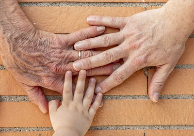 Cropped hands on wall