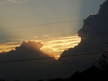 Low angle view of power lines against sky