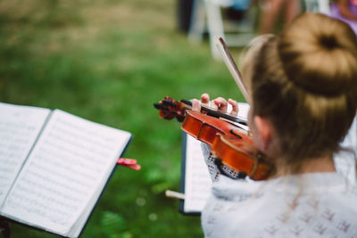 Midsection of man playing violin