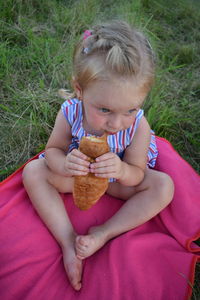 Boy eating food on grass