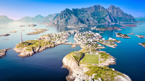 High angle view of sea and mountains against sky