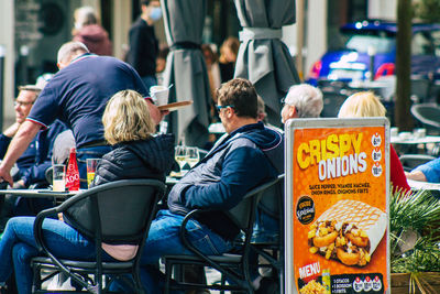 Rear view of people on street in city