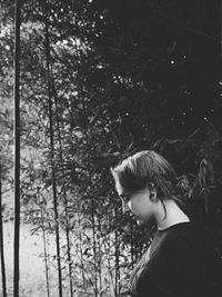 Woman standing on tree trunk