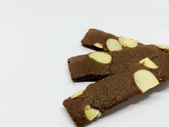 Close-up of cake on plate against white background