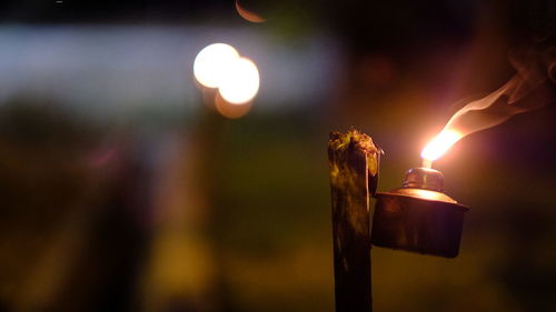 Close-up of illuminated candles against blurred background
