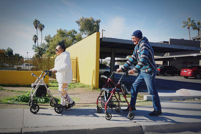 People on bicycle against sky