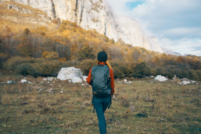 Rear view of man standing on rock