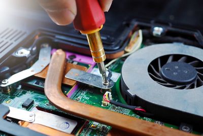Close-up of person working on machine