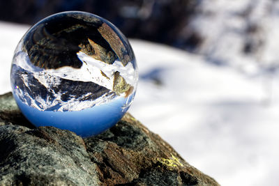 Close-up of crystal ball on rock