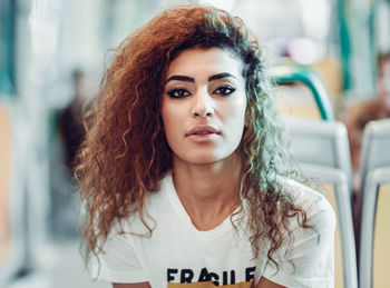 Portrait of young woman traveling in train