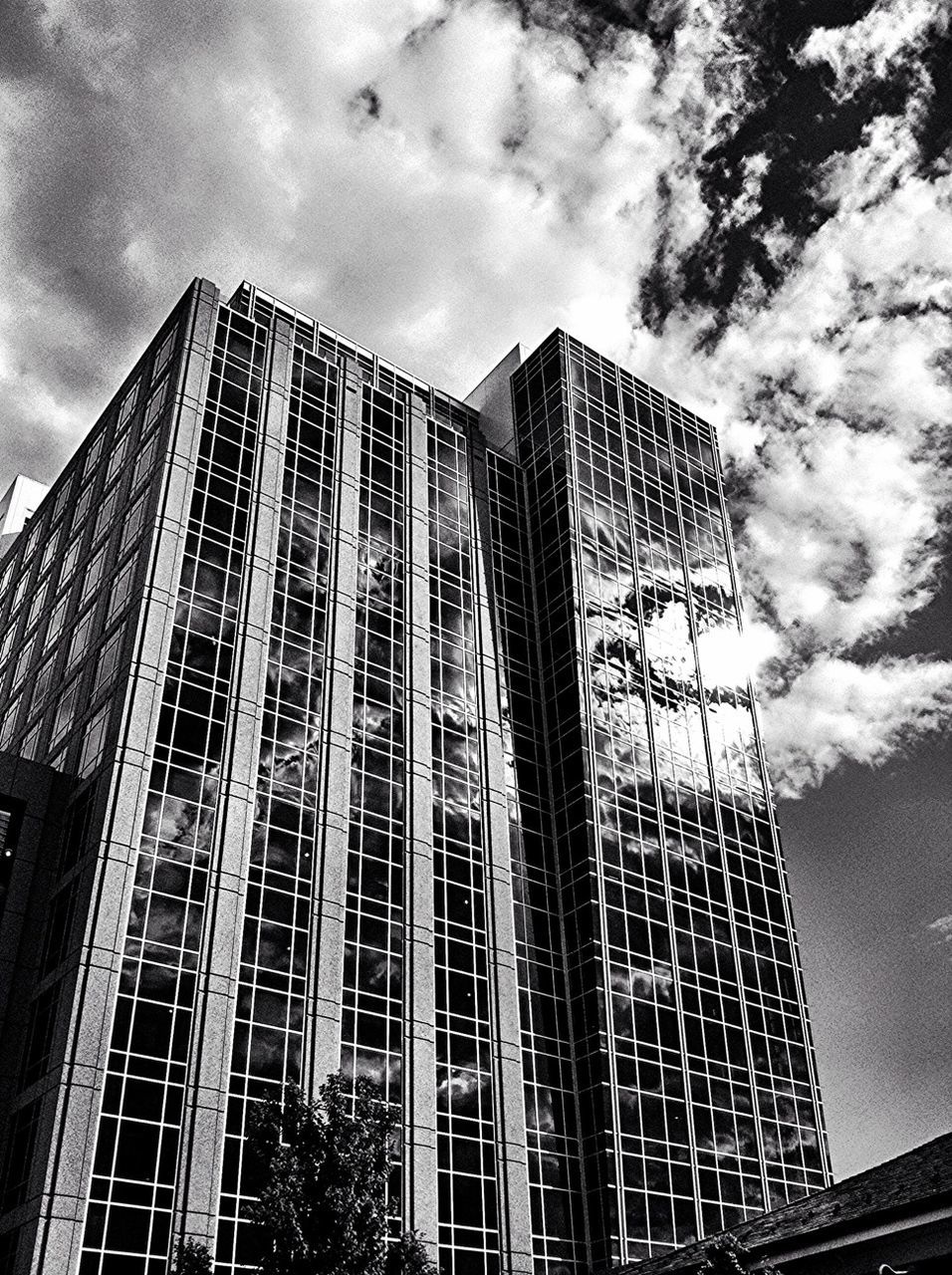 architecture, building exterior, built structure, low angle view, sky, modern, cloud - sky, city, office building, cloudy, skyscraper, glass - material, building, tall - high, reflection, tower, window, weather, cloud, day