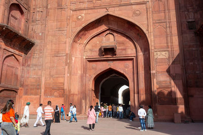 Group of people walking in historic building