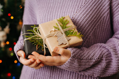 Midsection of woman holding christmas tree