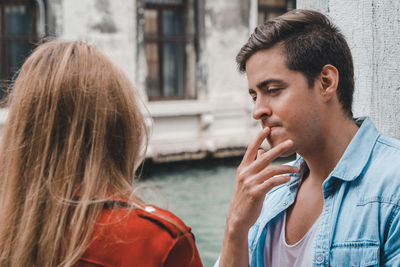 Thoughtful young couple by river 