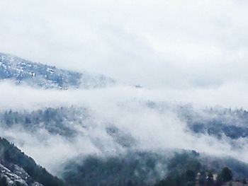 Scenic view of snow covered mountains against sky