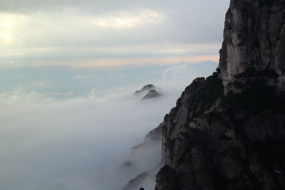 Scenic view of sea and mountains against sky