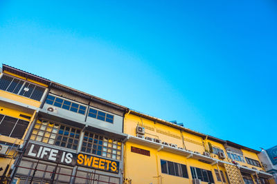 Low angle view of train against clear blue sky