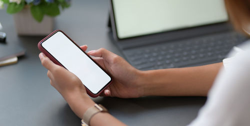 Midsection of woman using mobile phone