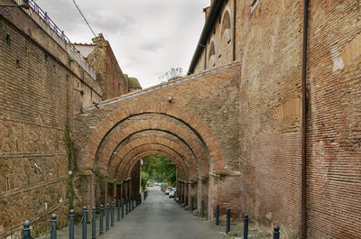 Alley amidst buildings against sky